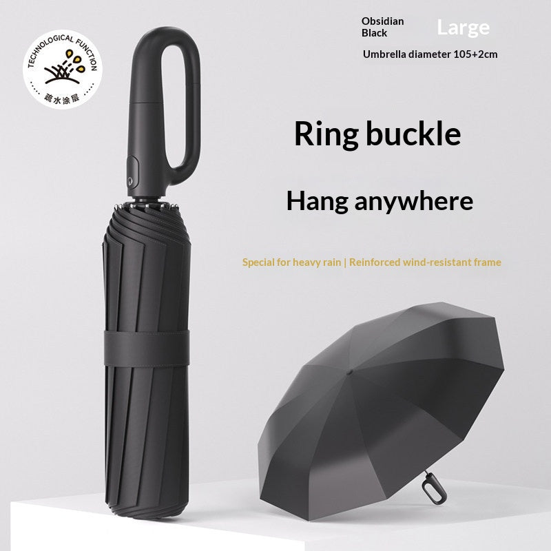 Closed folding umbrella beside an open dark canopy with ring handle