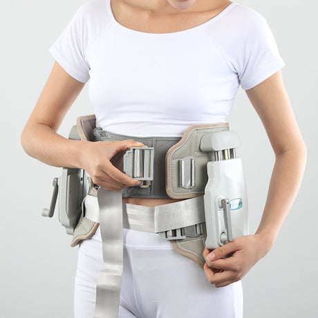 Lumbar traction device worn around waist, front view with grey straps and white side unit