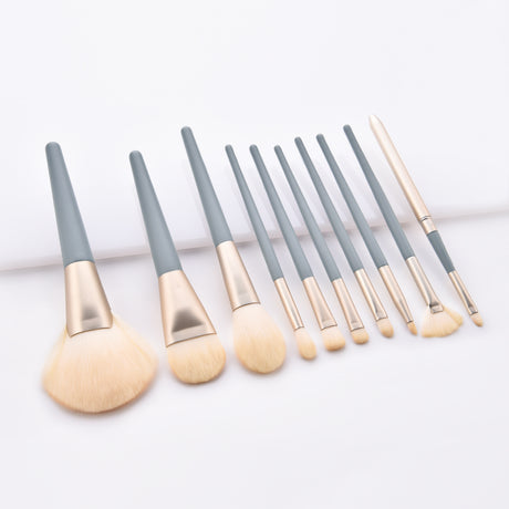 Makeup brush set arranged on a white stepped surface with blue handles