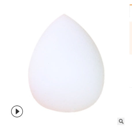 White teardrop makeup sponge puff on a plain background