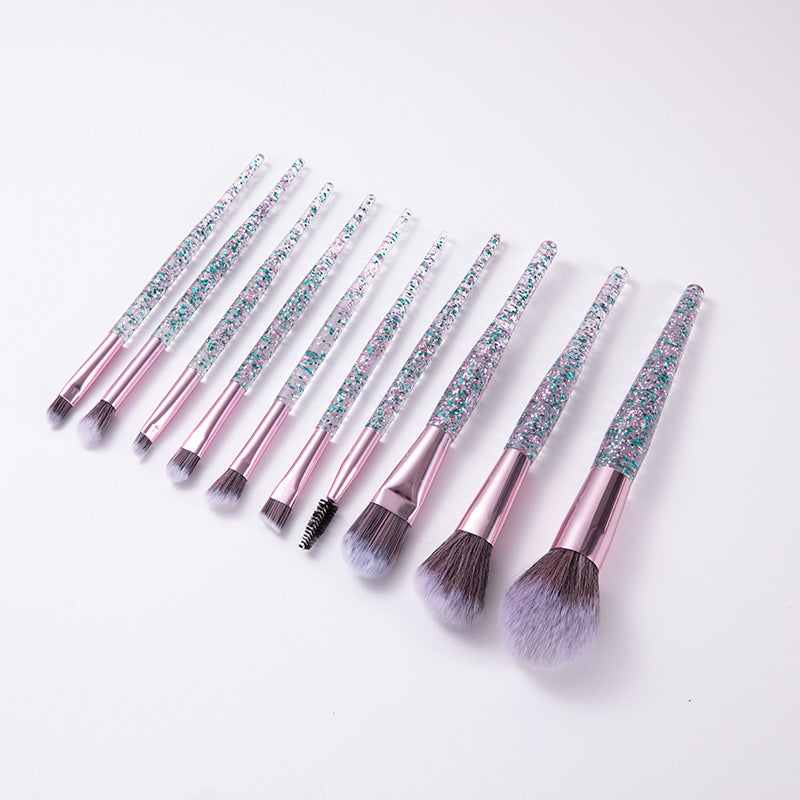 Angled row of makeup brushes with pink ferrules and blue glitter handles