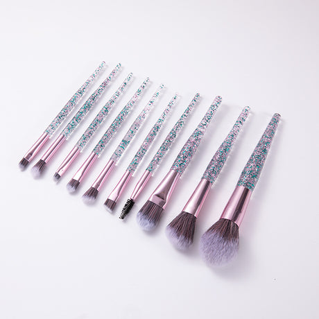 Angled row of makeup brushes with pink ferrules and blue glitter handles