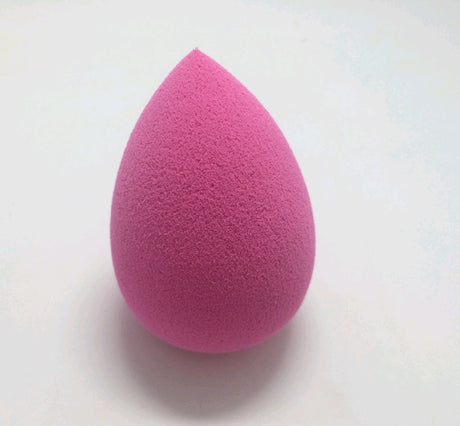 Rose pink teardrop Makeup Sponge Puff on a light surface