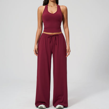 Women's burgundy halter crop top and matching wide leg trousers, front view.