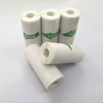 Five white paper rolls, some labelled with green OPEN arrows
