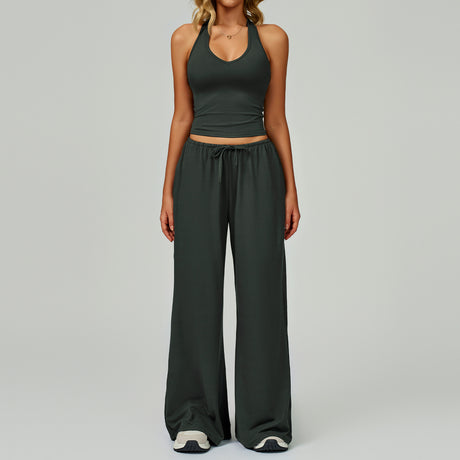 Women's dark green halter crop top and matching wide leg trousers.