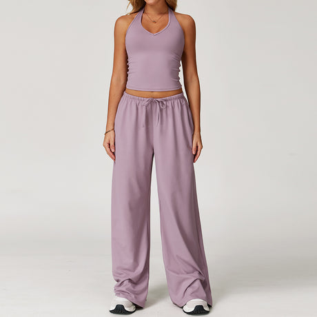 Women's lilac halter crop top and matching drawstring wide leg trousers.