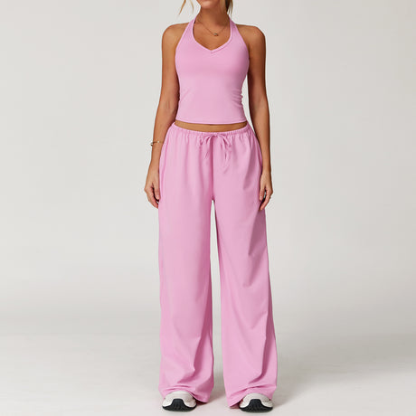 Women's pink halter crop top and matching drawstring wide leg trousers.