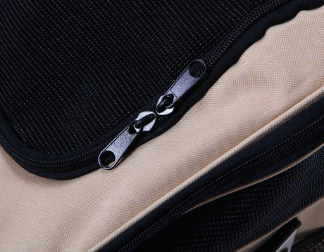 Close-up of beige carrier with black mesh panel and two zip pulls