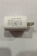 White power adapter with printed label and flat metal pins partially visible