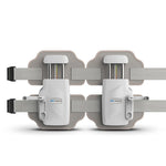 Front view of grey and white lumbar traction device laid flat with extended straps