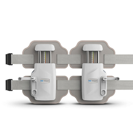 Front view of grey and white lumbar traction device laid flat with extended straps