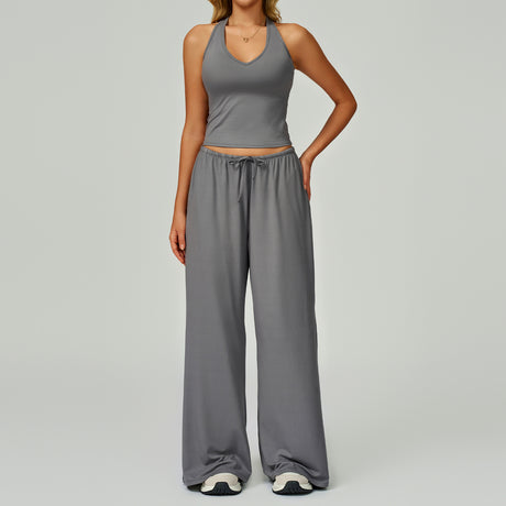 Women's grey halter crop top and matching drawstring wide leg trousers.