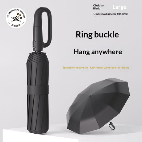 Closed folding umbrella beside an open dark canopy with ring handle