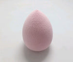 Pale pink teardrop Makeup Sponge Puff on a light surface