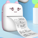 Pink mini printer on a blue tabletop, printing an illustrated sheet