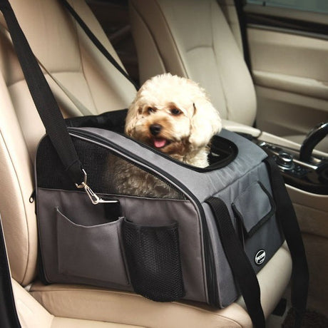 Grey pet travel carrier on a car seat with a small dog inside