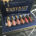Open navy Beauty Glazed box showing six lipsticks from nude to red shades