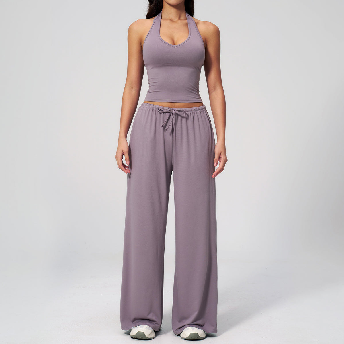 Women's mauve halter crop top and matching drawstring wide leg trousers, front view.