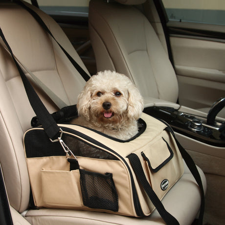 Beige pet travel carrier on a car seat with a small dog inside