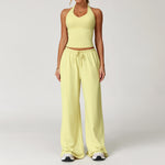 Women's yellow halter crop top and matching drawstring wide leg trousers.