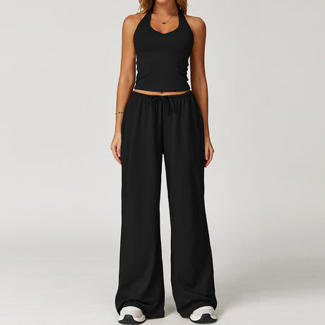 Women's black halter crop top and matching wide leg trousers, front view.