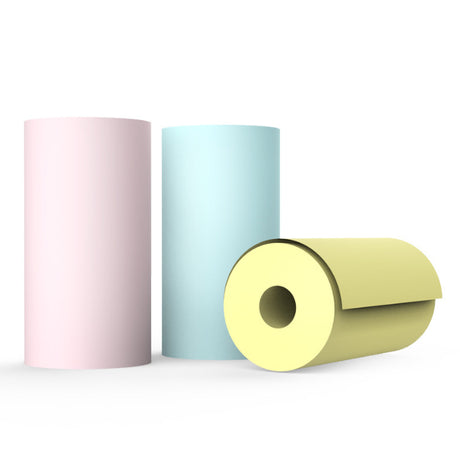 Pink, blue and yellow printer paper rolls on a white background