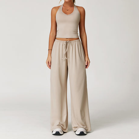 Women's beige halter crop top and matching drawstring wide leg trousers.