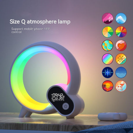 Q Light clock glowing with rainbow ring and remote on bedside table