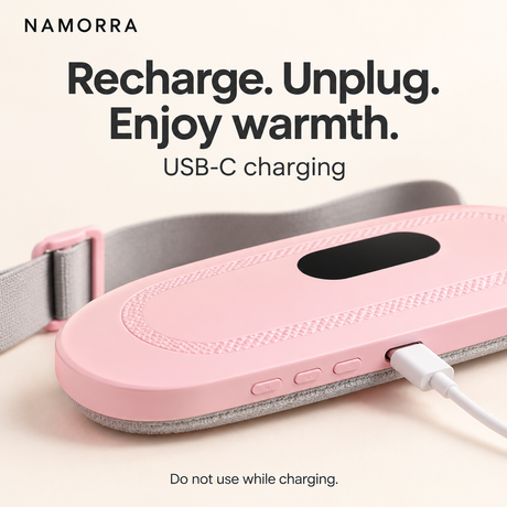 NAMORRA waist belt on a table connected to a USB-C cable for charging; unplug before use.