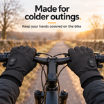 Black heated gloves worn on bicycle handlebars on a cold morning