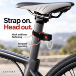Close-up of circular rear light strap fastening around bicycle seatpost